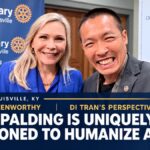 Spalding University President Dr. Anne Kenworthy and Di Tran smiling together at the Rotary Club of Louisville, with a feature headline about humanizing AI.